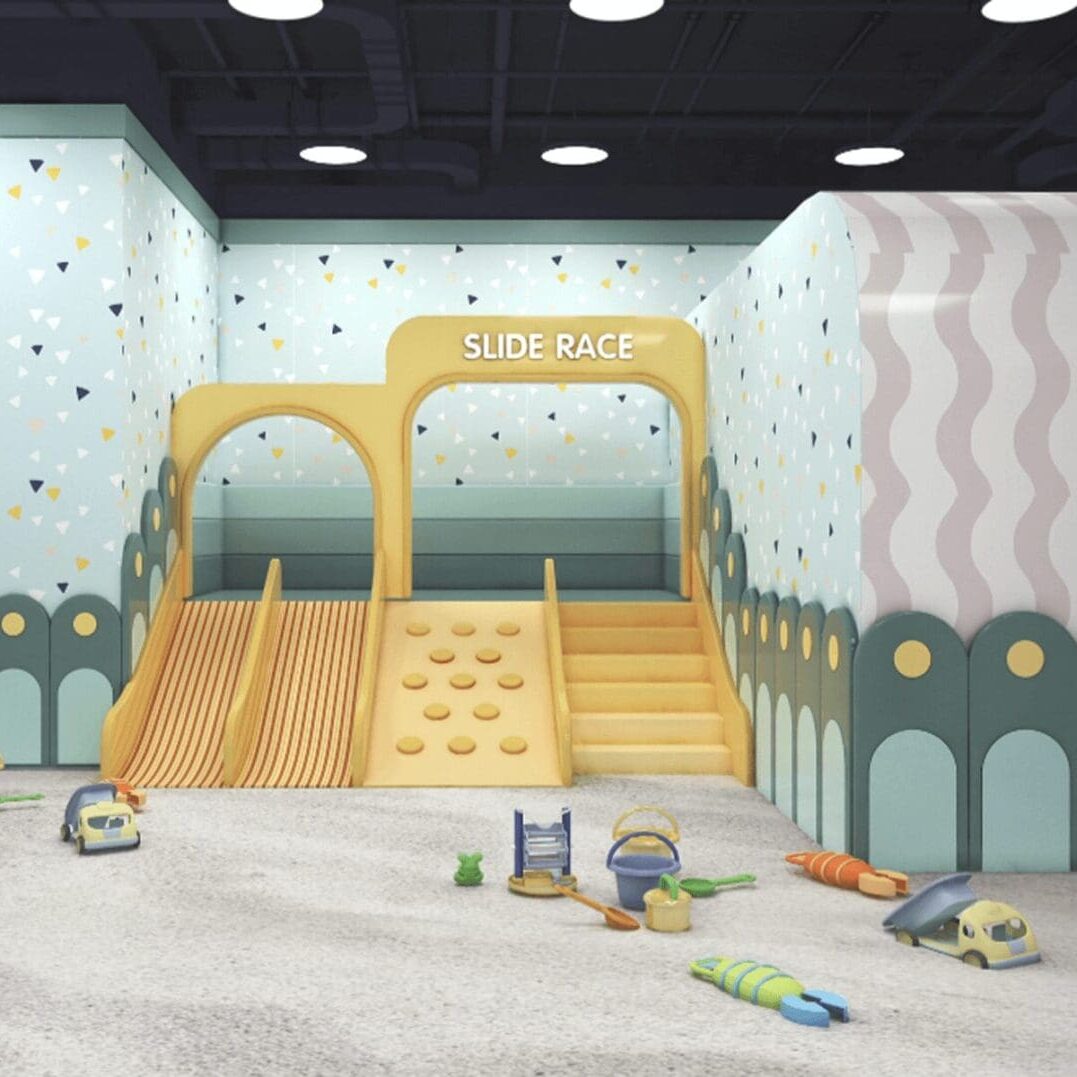 Indoor children's play area with slides and climbing wall.